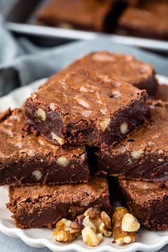 several pieces of brownie on a plate with walnuts