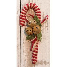 a christmas decoration hanging on the side of a door with candy canes and candies