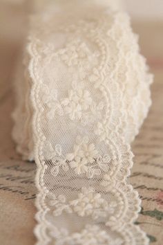 a white lace is laying on top of a table