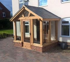 a wooden gazebo sitting on top of a brick patio