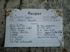 a recipe board with instructions on it sitting on a granite counter top in front of a marble wall