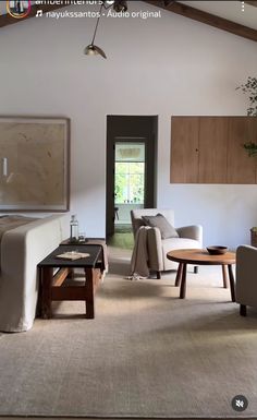 a living room filled with furniture and a wooden ceiling mounted to the side of a wall