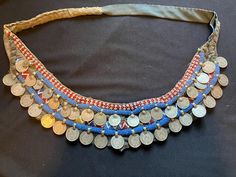 48 inches long - 4 inches of embellishment  a coin from India from 1917  I assume this was made in the late 50s the use was as a bandolier  it could be turned into a belt but i think it's way too collectible to do that !  Amazing piece from my collection Handmade Vintage Coin Necklace For Festivals, Vintage Handmade Coin Necklace For Festivals, Antique Handmade Coin Necklace For Festival, Handmade Antique Coin Necklace For Festival, Bohemian Coin Necklace For Festivals, Vintage Ceremonial Coin Necklaces, Vintage Ceremonial Coin Necklace, Traditional Coin Necklaces As Collectibles, Traditional Coin Necklaces For Collectors