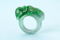 Carved Jade Rings For A Gift, Carved Jade Rings As A Gift, Green Carved Rings For Formal Occasions, Green Intaglio Ring Jewelry, Formal Carved Green Ring, Formal Green Carved Ring, Carved Jade Ring Jewelry, Unique Carved Round Rings, Unique Jade Gemstone Ring