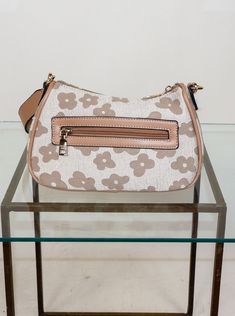 Effortlessly elevate your style with our Asia Floral Shoulder Bag. Designed with a beautiful floral pattern, this cross body bag is the perfect accessory for any outfit. Its convenient strap allows for hands-free carrying, making it both stylish and practical. Upgrade your wardrobe with this must-have bag. Brand: Jen&Co EH2458 Trendy Spring Crossbody Hobo Bag, Trendy Crossbody Hobo Bag For Spring, Floral Print Shoulder Bag For Everyday Use, Chic Daily Use Bags With Floral Print, Chic Floral Print Bags For Daily Use, Chic Bags With Floral Print For Daily Use, Spring On-the-go Bag With Adjustable Strap, Spring Beige Shoulder Baguette Bag, Trendy Floral Print Travel Shoulder Bag