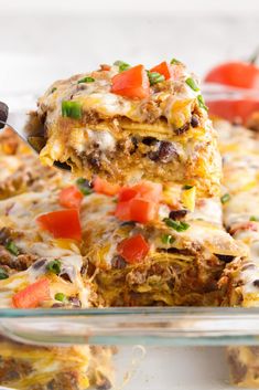 a casserole dish with meat, vegetables and cheese on top is being lifted from the casserole dish