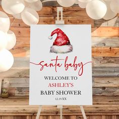 a sign that says santa baby welcome to ashley's baby shower