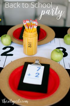 back to school party table setting with place cards and pencils in mason jar on red plate