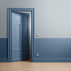 an empty room with a blue door and wooden parquet floor in front of it