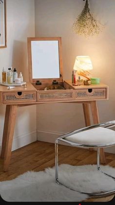 a desk with a mirror, stool and other items on it