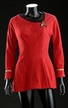 a mannequin wearing a red jacket with gold trims and a star trek insignia on it