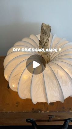 a large white pumpkin sitting on top of a wooden table