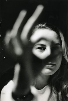 black and white photograph of a woman making a hand gesture