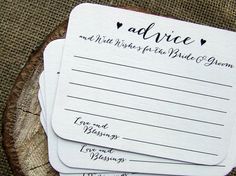 three wedding advice cards sitting on top of a tree stump