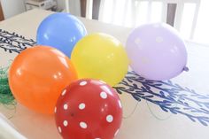 four balloons sitting on top of a table