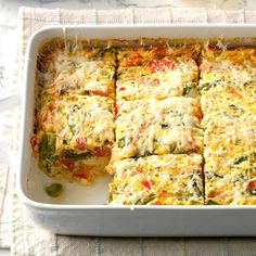 a casserole dish filled with vegetables and cheese