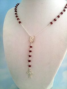 "This is a gorgeous rosary necklace made with genuine 2.5-3mm faceted Garnet gemstones on .925 Sterling Silver chain. The beautiful Sterling Silver Miraculous Mary medallion hangs at center with 3\" drop that has a plain cross pendant. Please note that the cross pendant on this necklace has changed. You receive the cross pendant you can view in the last photo. Necklace may be ordered in a 16\", 18\", 20\" 22\" or 24\" length around the neck. (Priced accordingly, you choose size). Has spring clos Crucifix Jewelry With Faceted Beads For Gift, Crucifix Jewelry With Faceted Beads As Gift, Crucifix Shaped Jewelry With Faceted Beads As Gift, Cross-shaped Faceted Beads For Jewelry Making, Spiritual Crucifix Jewelry With Faceted Beads, Cross Necklace Women, Cross Necklaces, Necklaces Women, Rosary Necklace