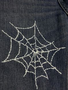 a spider web is drawn on the back of a pair of jeans