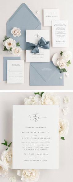 the wedding stationery is laid out on top of each other, with white flowers and blue envelopes