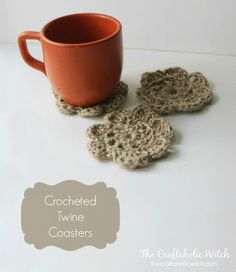 crocheted wine coasters are sitting on a table next to a coffee cup