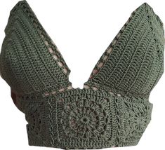 a green crocheted bralet with buttons on the front and back, made out of yarn