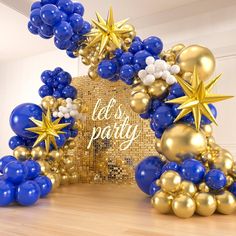 blue and gold balloon arch with stars on it