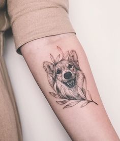 a woman's arm with a tattoo of a dog on the left side of her arm