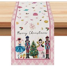 a christmas card with three nutcrackers and a tree in the center on a wooden table