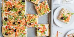 the pizza is cut into squares and ready to be eaten