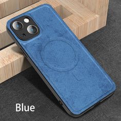 a blue iphone case sitting on top of a wooden table next to a planter