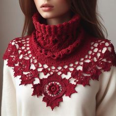 a doll wearing a red crocheted scarf