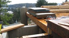 some wood is stacked on top of each other and ready to be put into the building