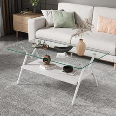 a living room with a white couch and glass coffee table