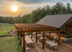 an outdoor dining area in the middle of a vineyard with tables and chairs around it