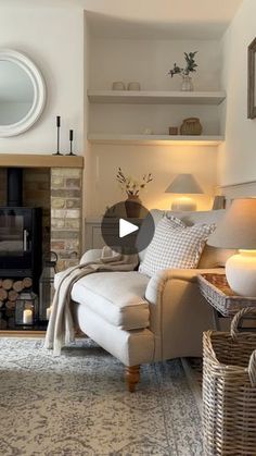 a living room filled with furniture and a fire place in front of a mirror on the wall