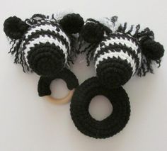 black and white crocheted zebra teeth with wooden ring for teeth, on white background