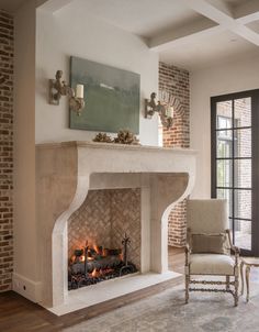 a living room with a fire place in the middle and a painting on the wall