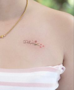 a close up of a woman's chest with a tattoo on it