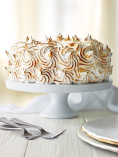 a cake with white frosting and swirls on top