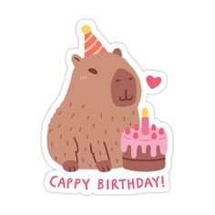 a brown bear sitting next to a birthday cake