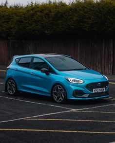 a blue ford fiesta parked in a parking lot