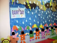 rain day bulletin board with paper cutouts and umbrellas on the wall, along with other decorations