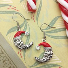 When you're making your Christmas list and checking it twice, these Santa earrings better be on it! The earring drop measures approximately 1 1/2". Shepherd's hooks with clear plastic stoppers make for easy wear. Since each pair is handmade, the earrings may vary slightly. Great news! When you purchase more than one item in the same order, each additional item will ship for FREE! Shop my store: www.etsy.com/shop/MyCraftyCollectibles ALL SALES ARE FINAL - NO REFUNDS OR EXCHANGES. Thank you! Photo decorations are not included. Nickel-free Round Christmas Earrings, Holiday Dangle Earrings With Ear Wire, Nickel-free Drop Earrings For Holiday, Nickel Free Christmas Drop Earrings, Christmas Gift Dangle Crystal Earrings, Christmas Gift Crystal Dangle Earrings, Nickel-free Dangle Jewelry For Christmas, Nickel-free Drop Earrings For Christmas, Holiday Silver Drop Earrings