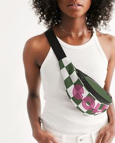 a woman wearing a white tank top holding a green and pink fanny bag