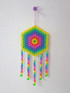 a multicolored beaded decoration hanging on a wall