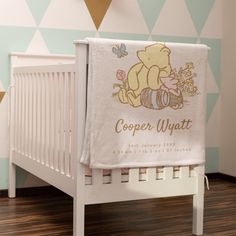 a baby crib with a winnie the pooh towel on it