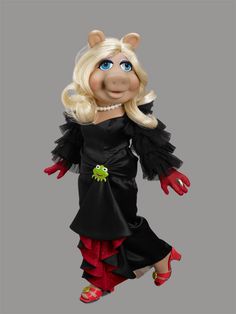 the miss piggy doll is dressed in black and red