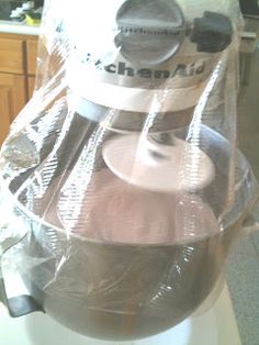 a kitchen mixer wrapped in plastic on top of a counter