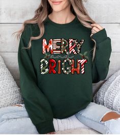 Get into the holiday spirit with our 'Merry and Bright' sweatshirt, a stylish and festive discovery from our Etsy Shop. This women's Christmas sweatshirt is crafted to bring a pop of color and joy to your holiday get-togethers, ideal for making cherished family moments or gifting to a loved one. ♥ PRODUCTION TIME: 1-5 days (Usually 2-3 days) ♥ SHIPPING TIME: 2-5 days (Usually 3 days) 🎁 LAST DAYS FOR CHRISTMAS DELIVERY 🎁 USA - 12/12/2023 ♥PRODUCT DESCRIPTION: Gildan Crewneck Unisex Sweatshirt S Festive Christmas Crew Neck Sweatshirt, Festive Holiday Crew Neck Sweatshirt, Holiday Crew Neck Sweater With Letter Print, Christmas Green Graphic Print Sweatshirt, Green Christmas Sweatshirt With Letter Print, Green Christmas Crew Neck Sweatshirt, Christmas Letter Print Crew Neck Sweater, Christmas Green Sweatshirt With Graphic Print, Christmas Sweater With Letter Print