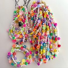 a bunch of beads are hanging on the wall next to some scissors and other items